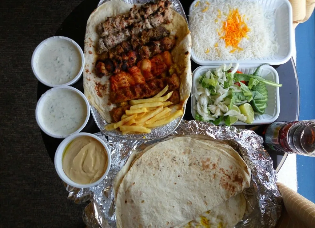 Kabab Khas — yogurt-marinated mutton and chicken on the grill, with naan and rice