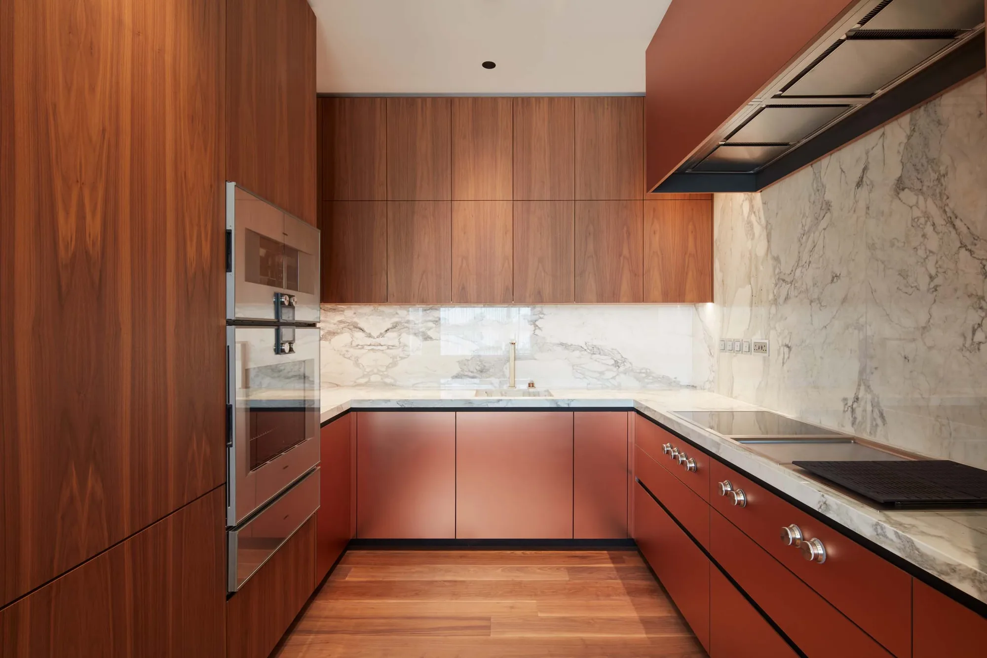 Walnut and clay-painted kitchen with Calacatta marble splashback — Al Barari residence, Dubai