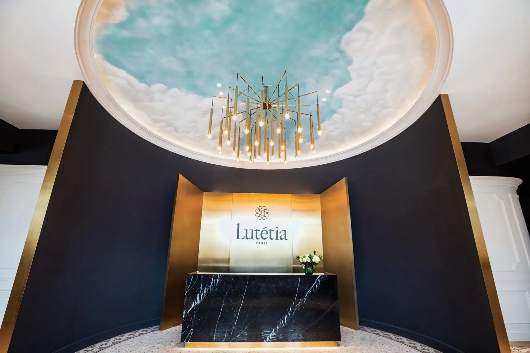 Maison Lutétia Dubai reception — printed-sky dome and Parisian-luxe interior
