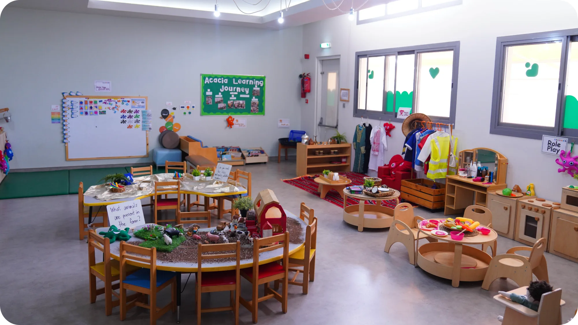 A bright Dibber classroom with low wooden furniture and natural materials