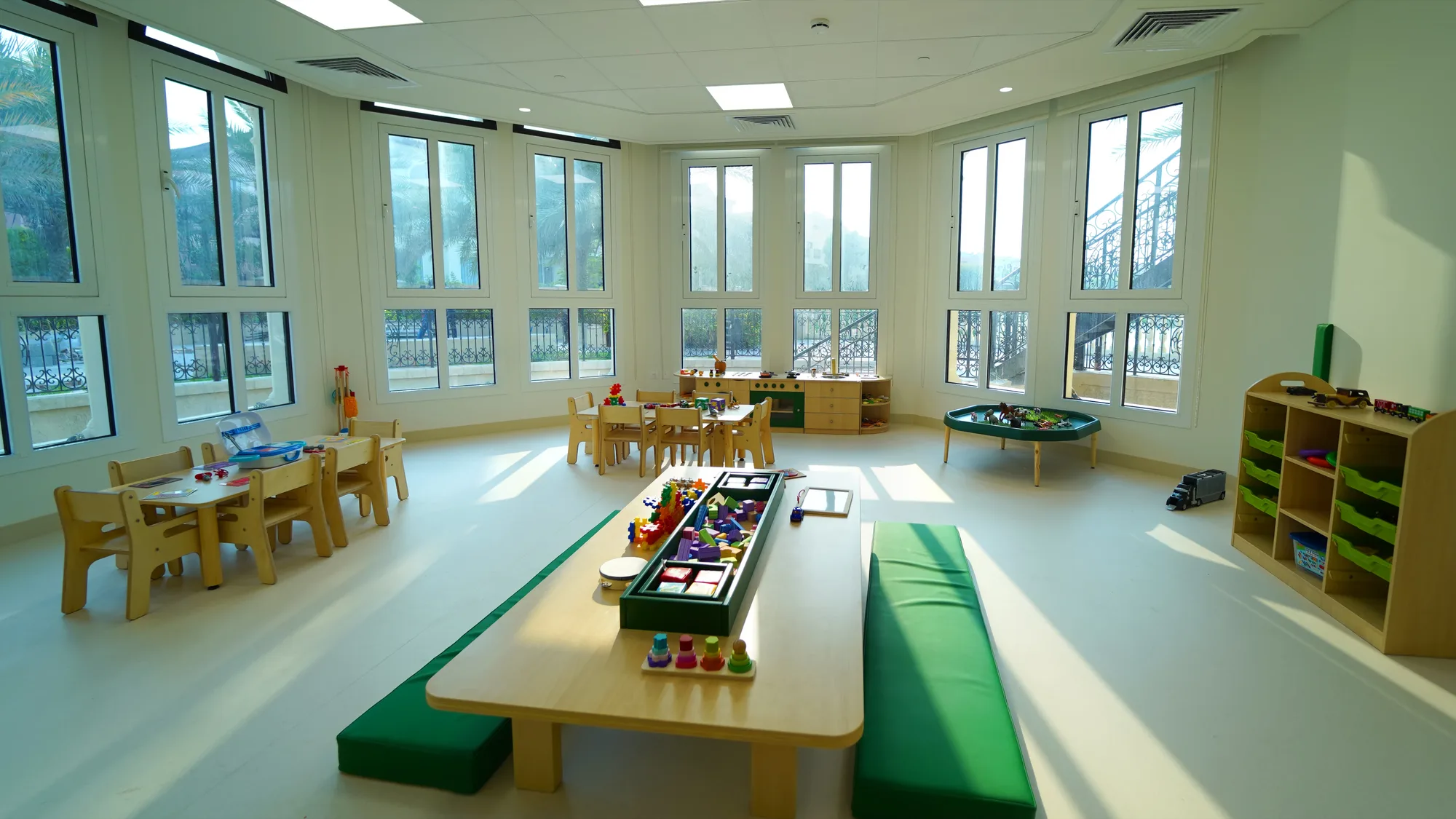 A Dibber Nordic classroom with low wooden tables, soft cushions and large windows