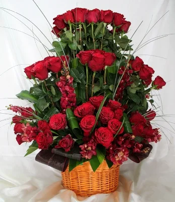 Tall mixed arrangement of lilies, roses and orchids