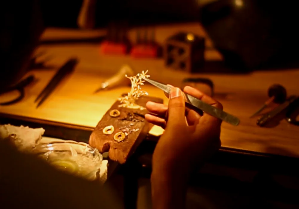 A Devji Aurum craftsman setting a piece at the bench by hand