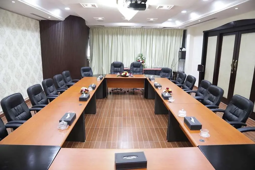 Boardroom-style meeting room set up with a U-shaped table