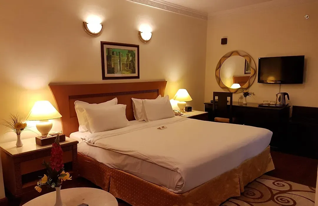 Standard room with a double bed and warm lighting