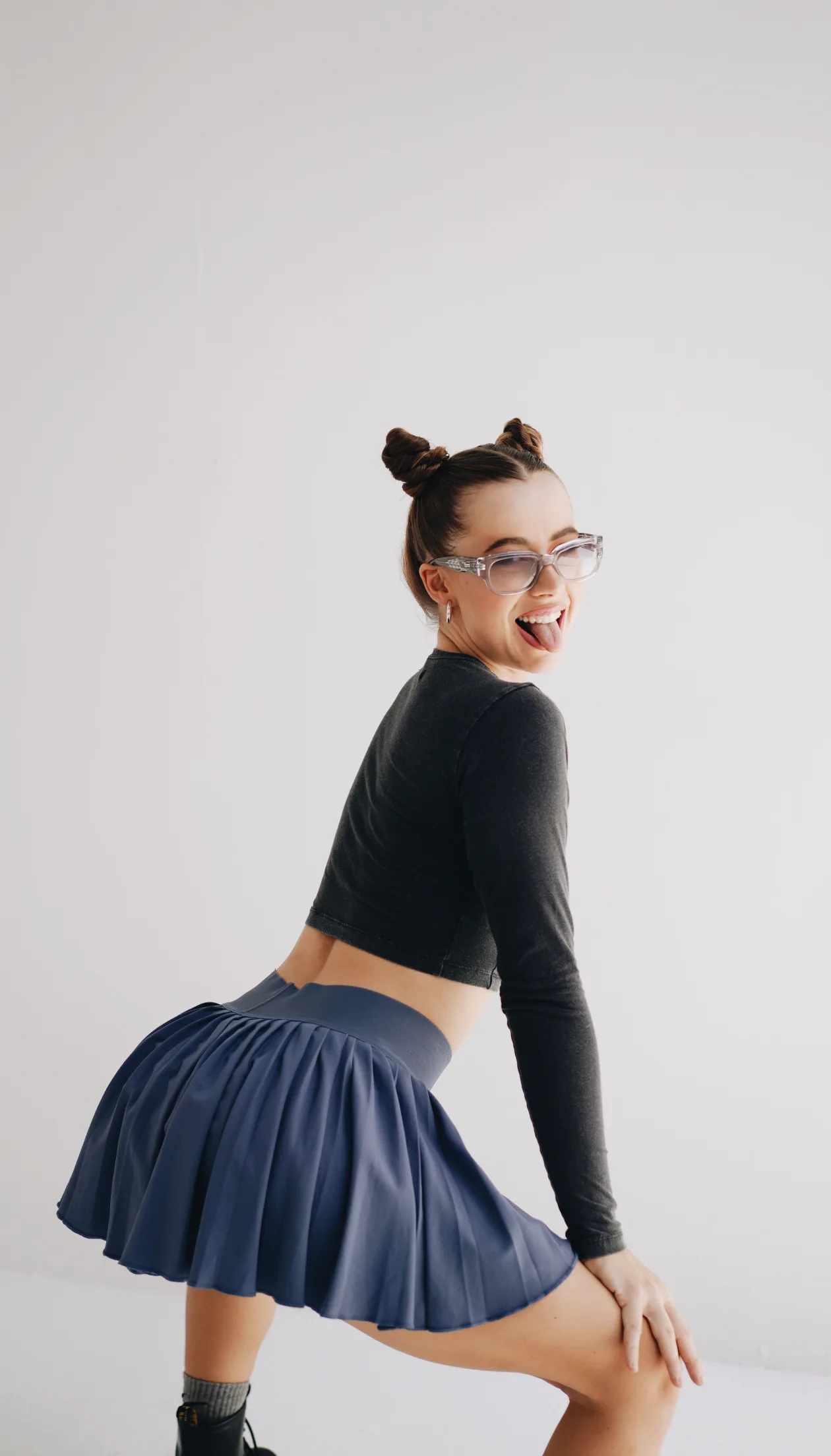 Dancer mid-move in a pleated skirt