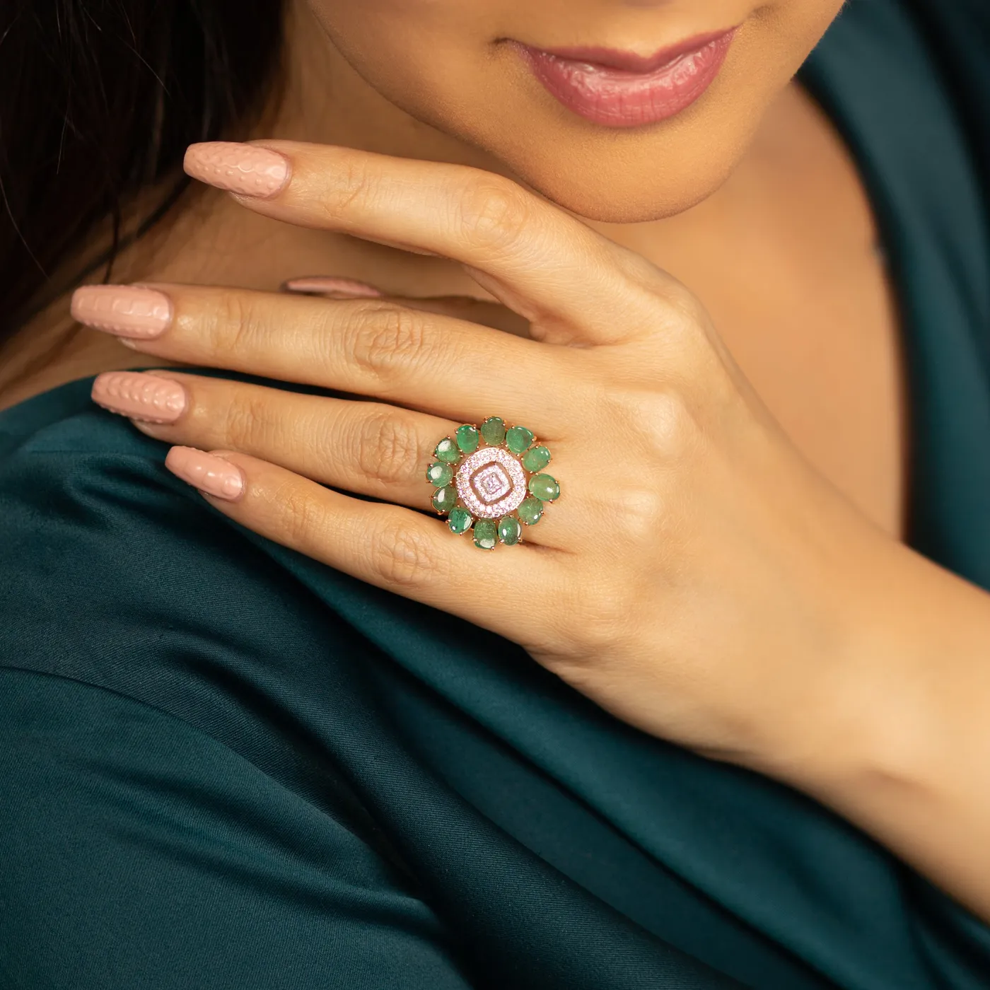 Emerald and pink-diamond fusion ring worn on hand