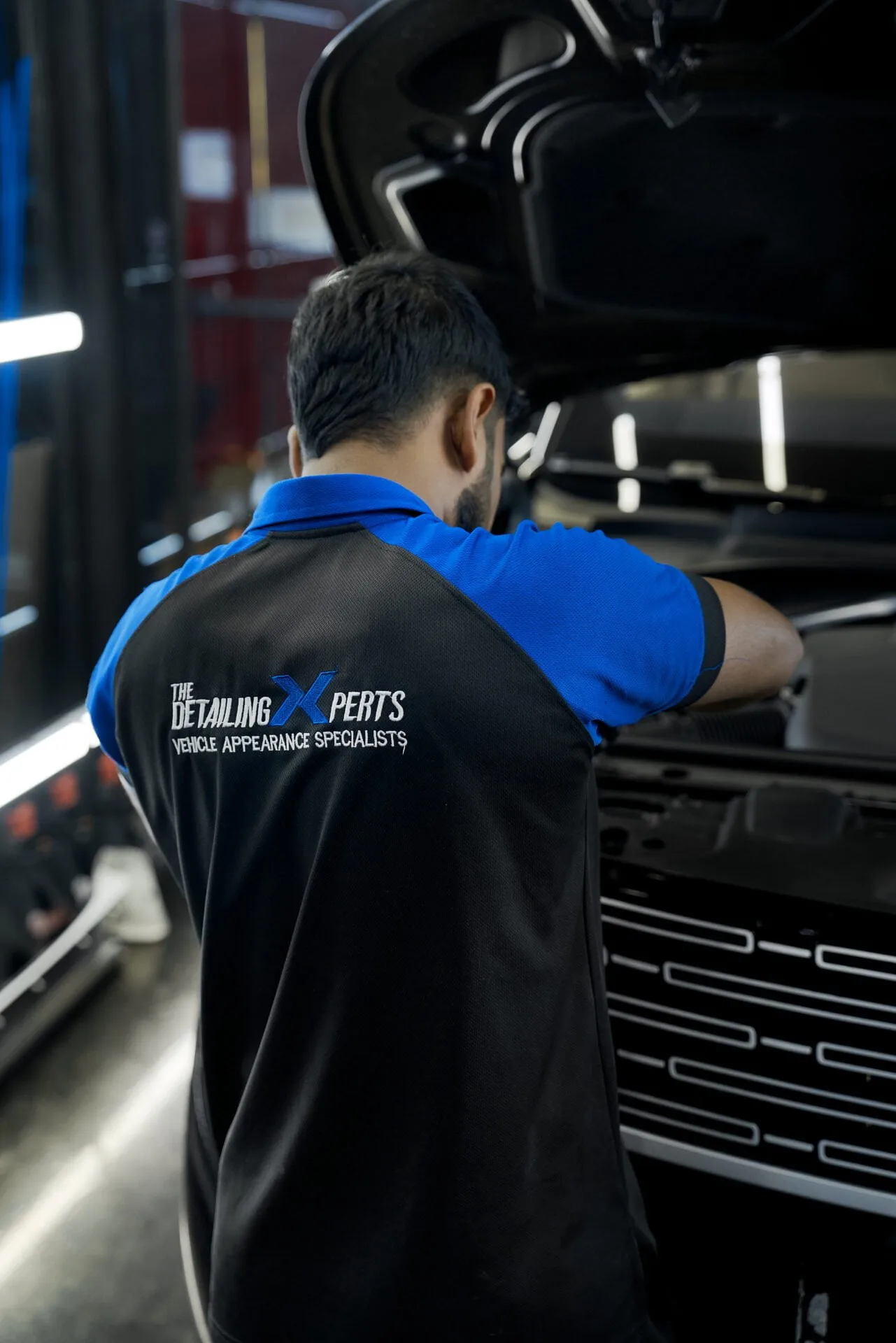 A Detailing Experts technician at work in the Dubai workshop