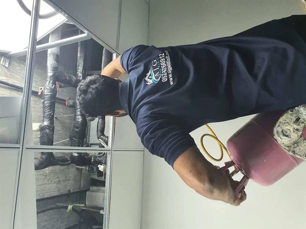 AJG technician installing duct insulation