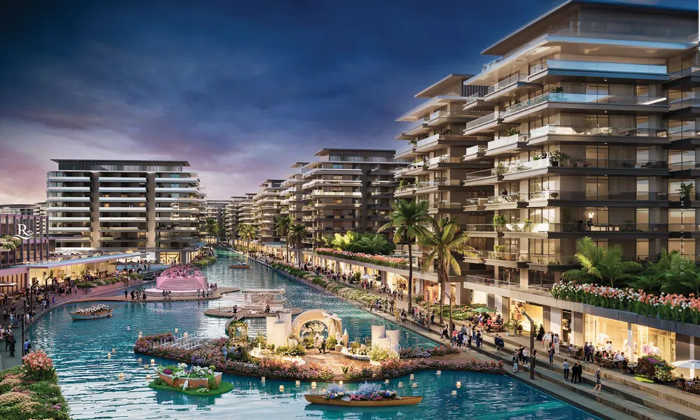 Damac Riverside waterfront residences along an illuminated canal promenade