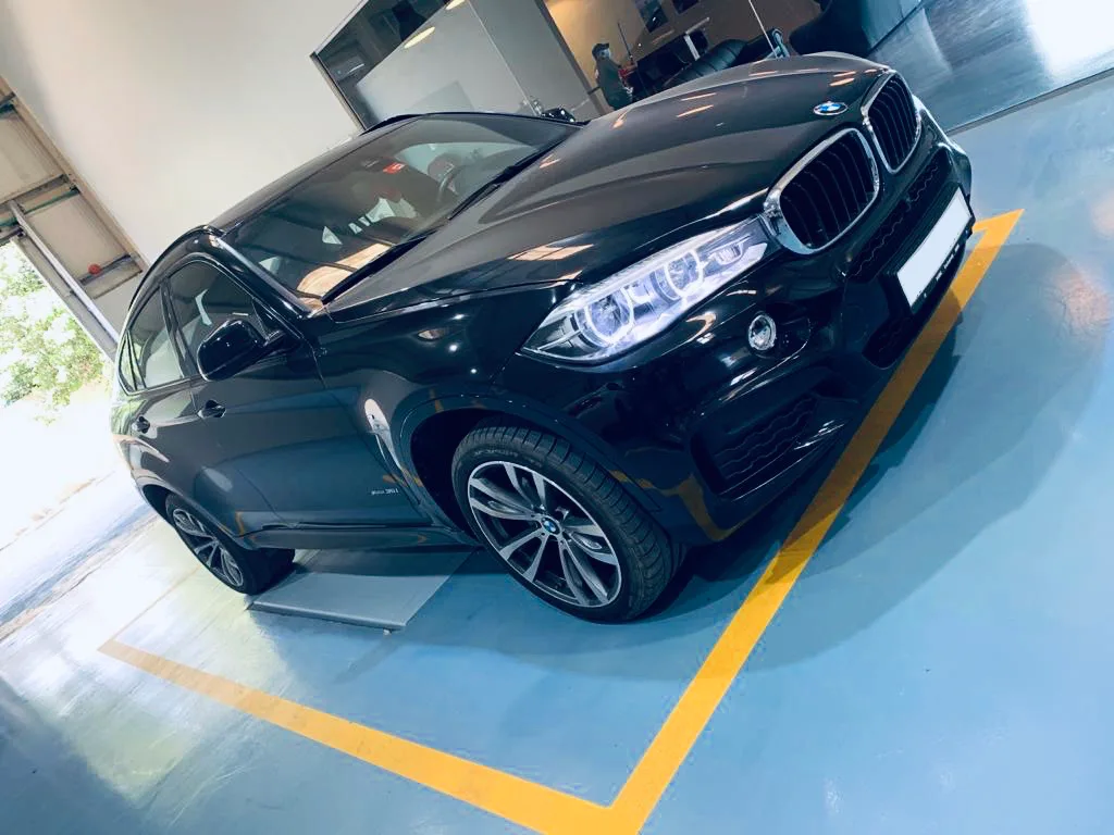 Black BMW X6 inside the workshop