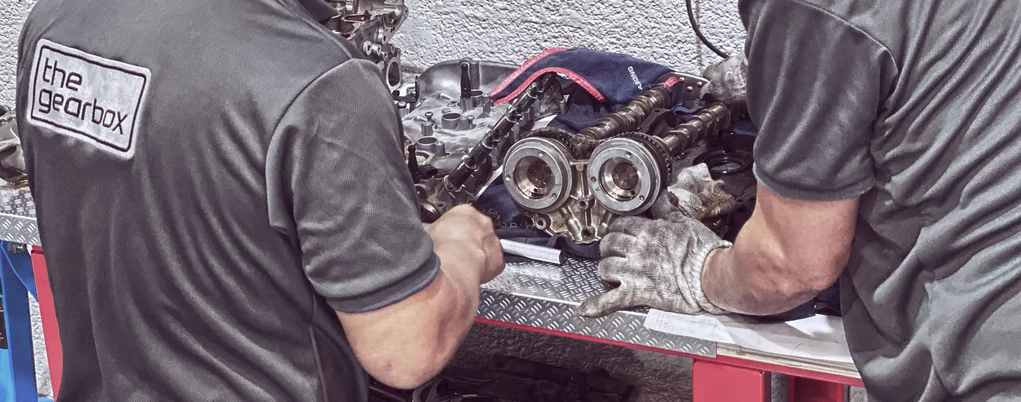 Gearbox technicians working on an engine