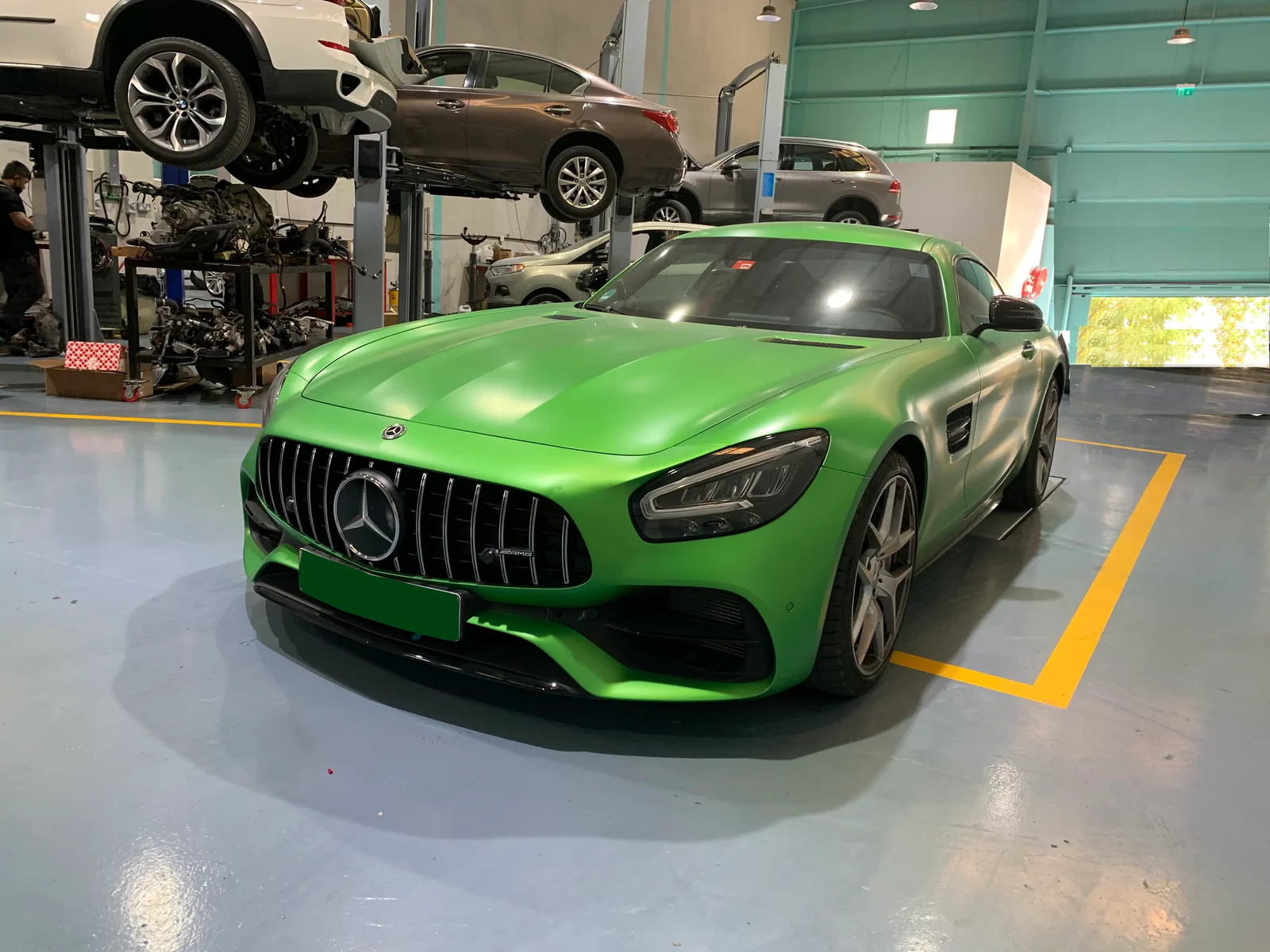 Mercedes-AMG GT and cars on hydraulic lifts
