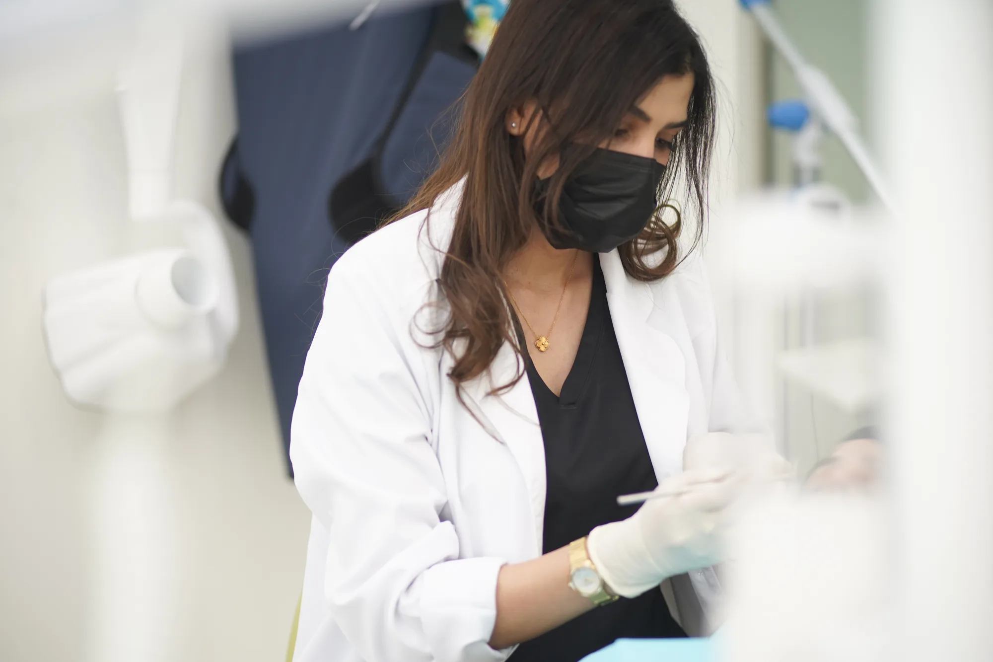 A Luzan dentist treating a patient in a bright, modern Dubai clinic