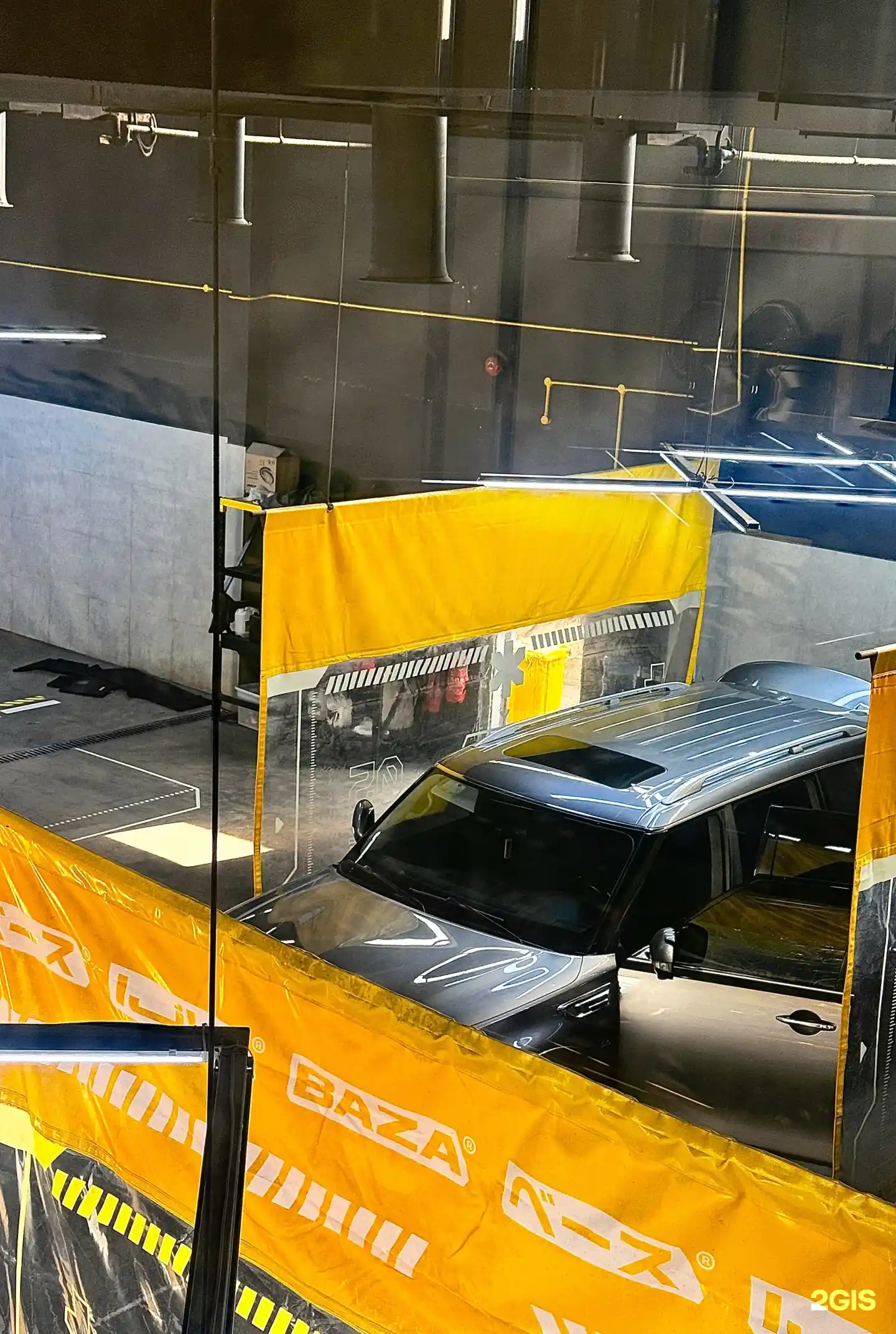 Car in BAZA wash bay with branded drapes