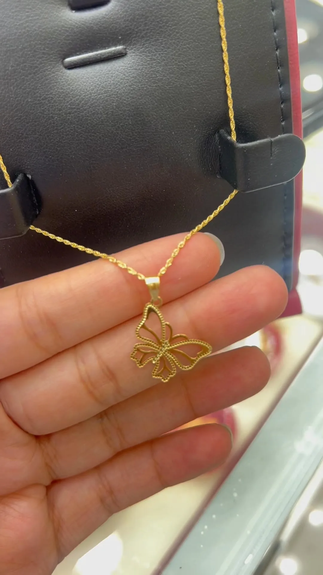 Gold butterfly pendant on a fine chain