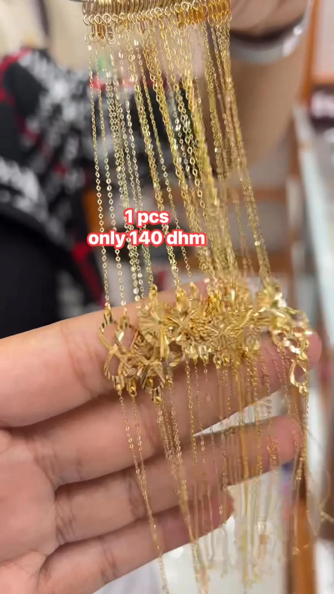 Fine gold chains and pendants on display