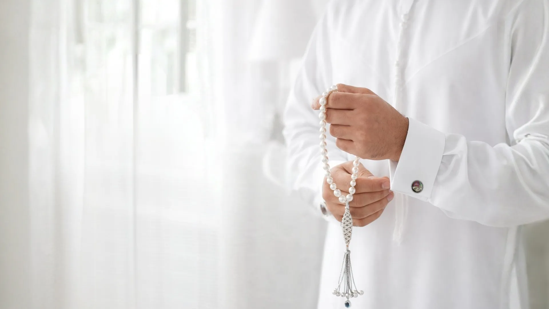 A moment of quiet contemplation, fine pearl jewellery held in hand