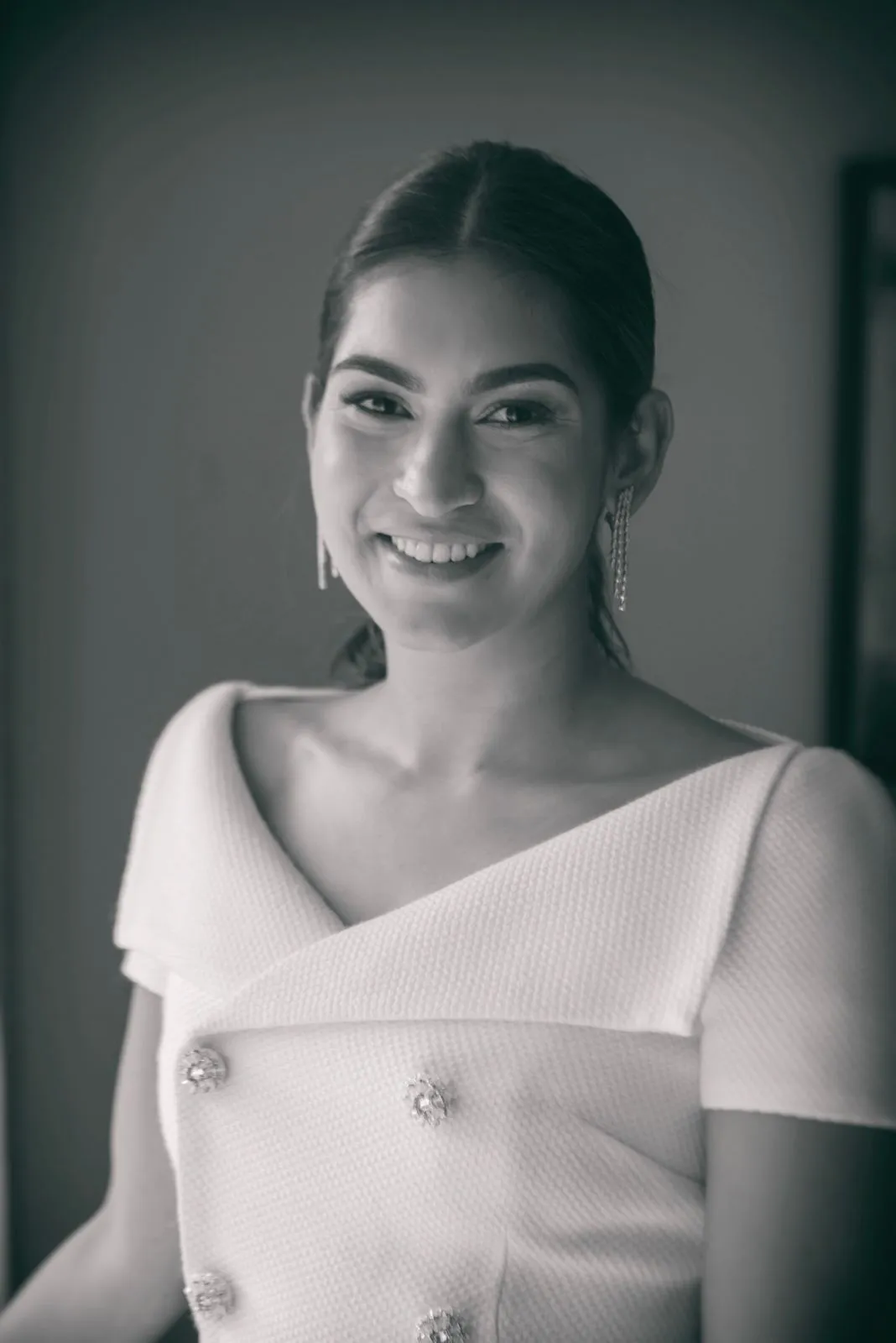 Portrait of an ISTANA client wearing fine diamond earrings