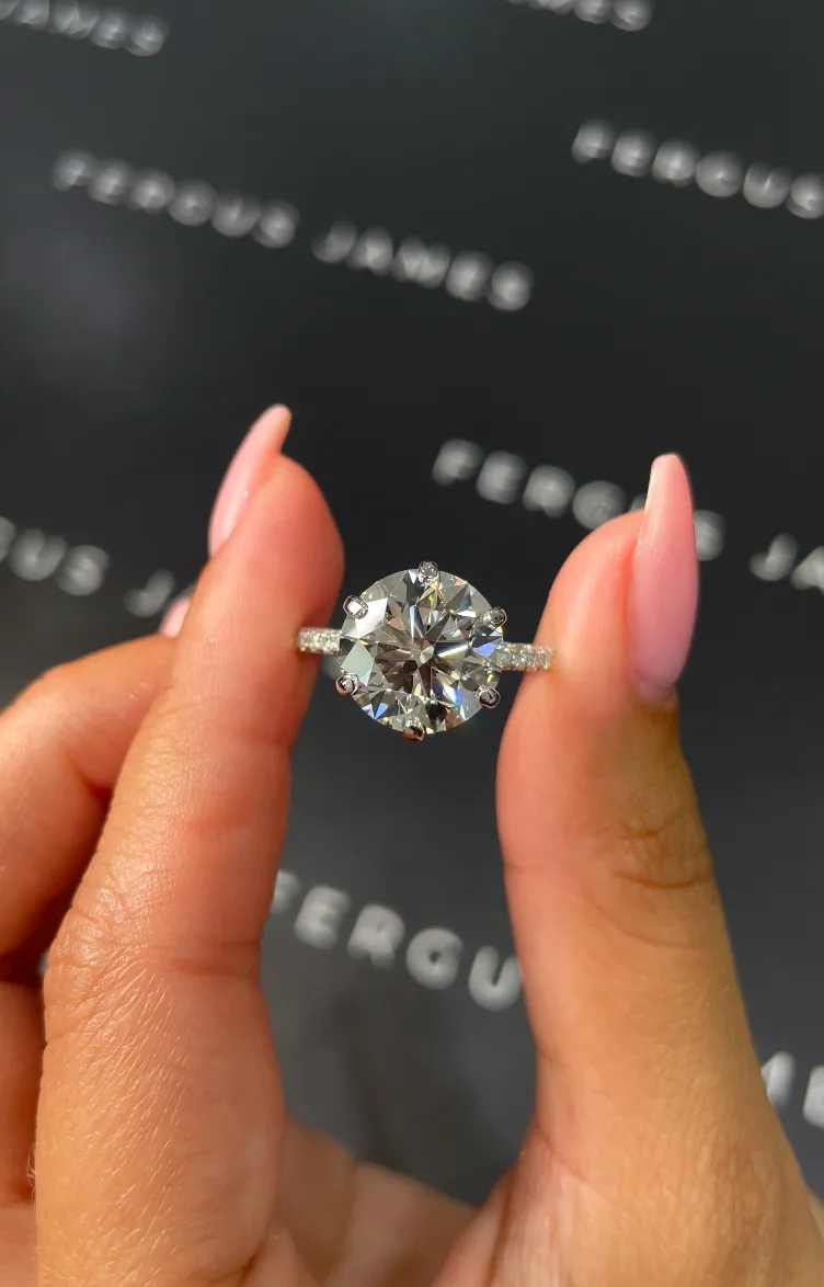 Bespoke radiant-cut diamond ring with pavé band
