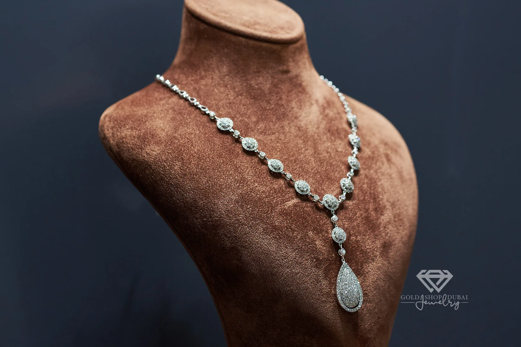 Diamond pavé drop necklace on a display bust