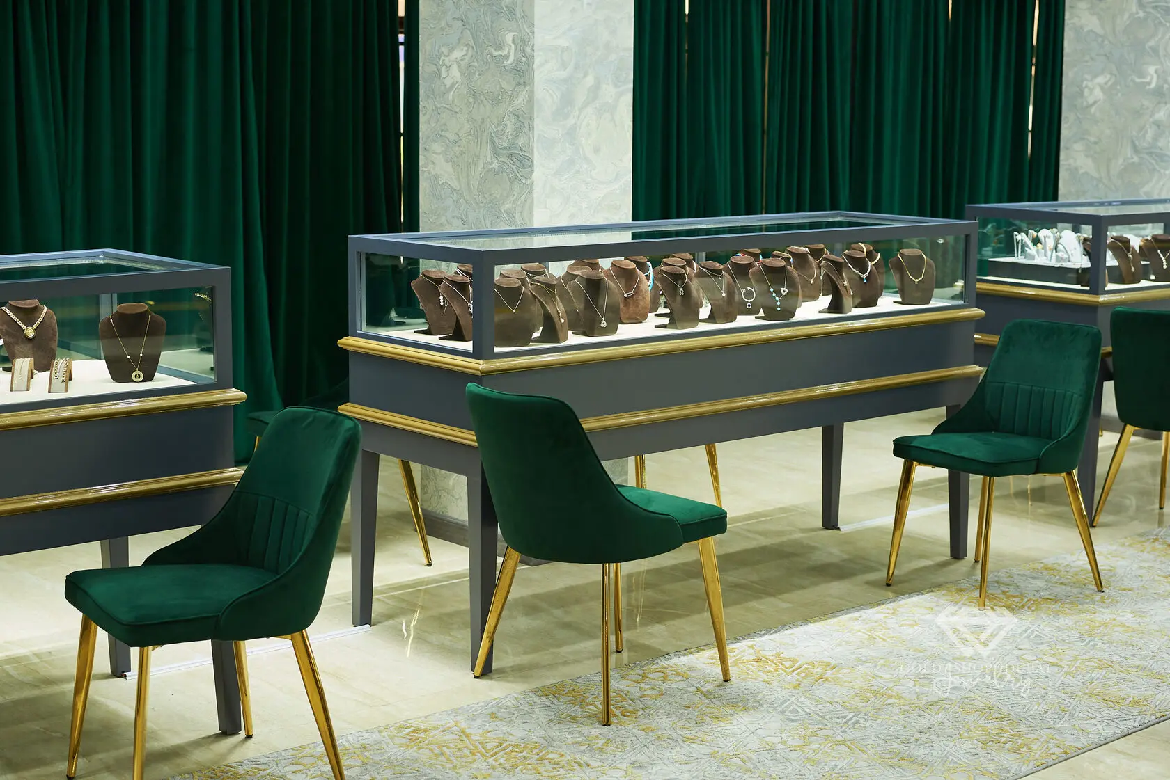 Gold Shop Dubai showroom seating with emerald velvet chairs and gold detailing