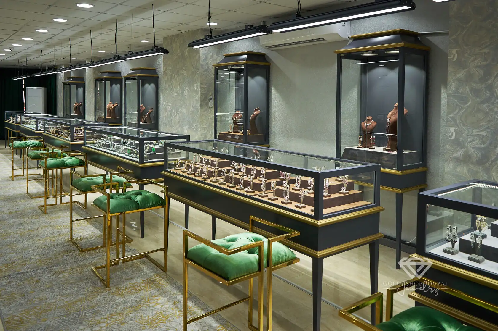 Inside the Gold Shop Dubai showroom — lit cabinets along a marble gallery