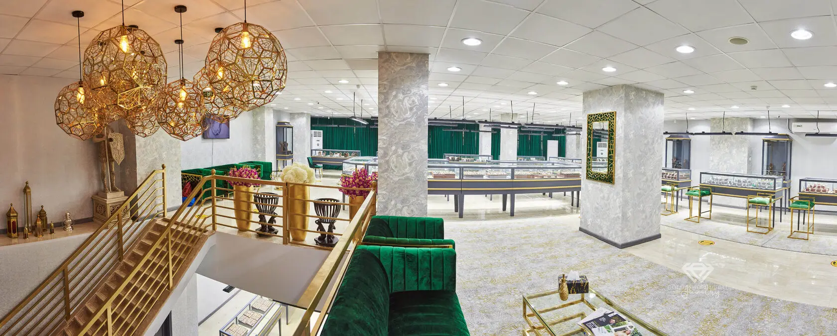 The Gold Shop Dubai showroom in Deira — lit display cabinets, emerald velvet seating and gold detailing