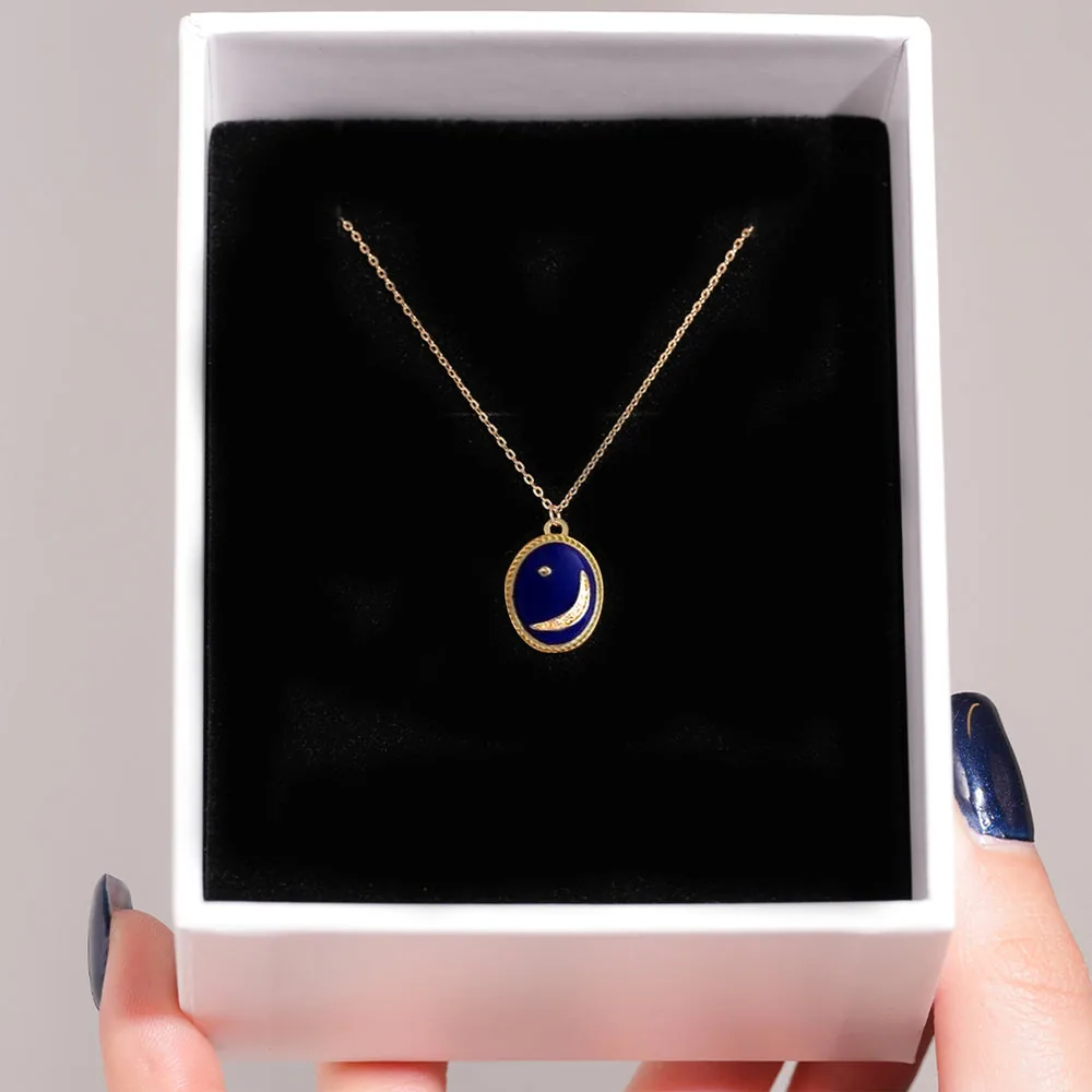 Gold and lapis crescent-moon pendant presented in a Jewelivery gift box