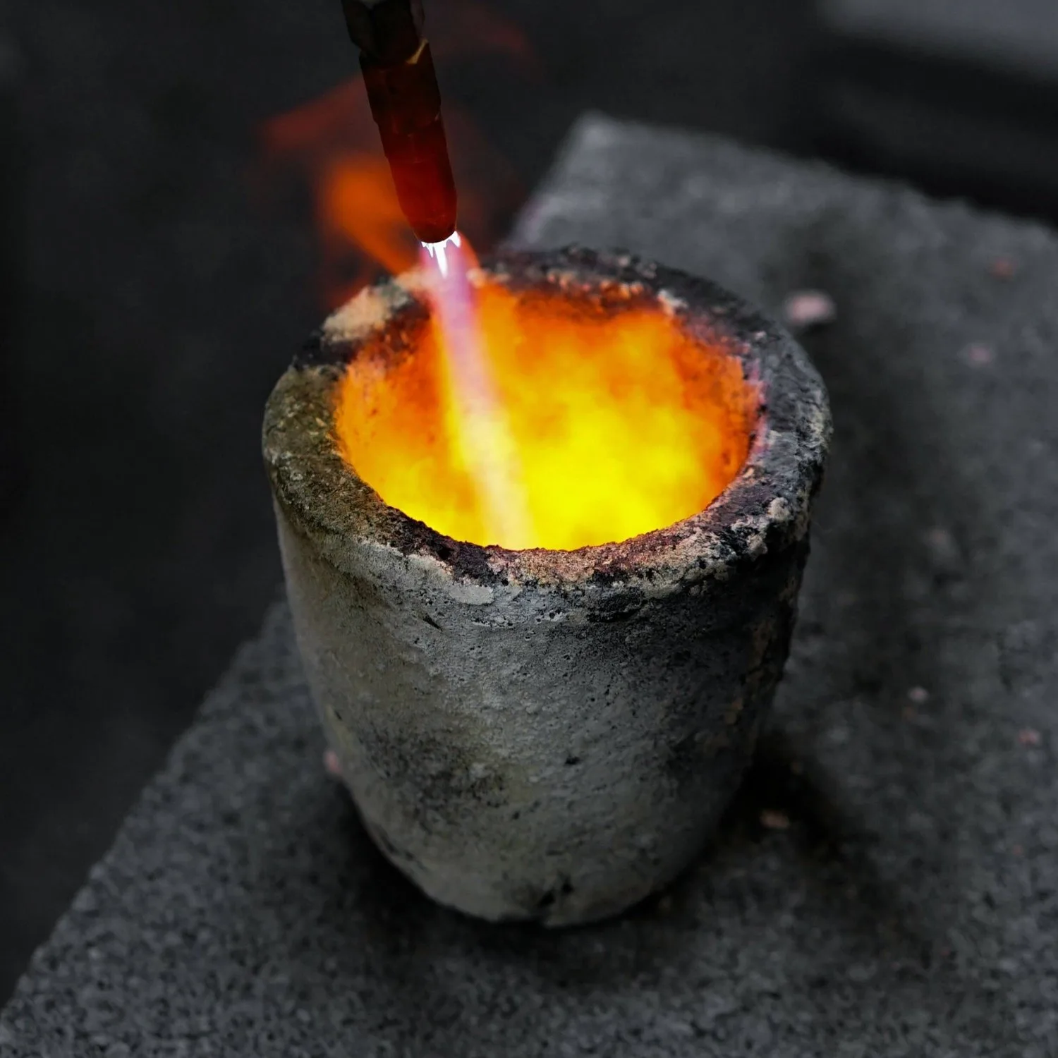Precious metal melted in a crucible during casting.