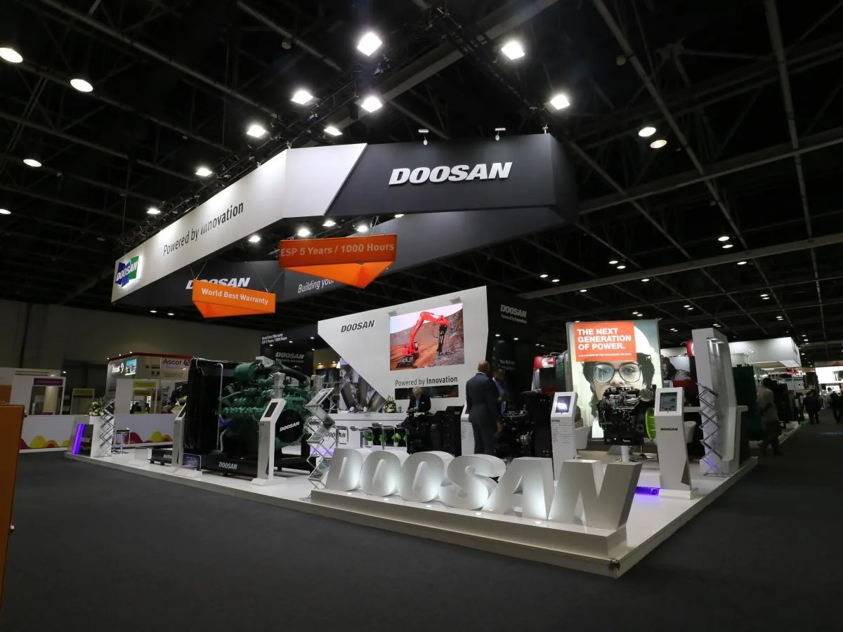DOOSAN exhibition stand interior with product displays and meeting area