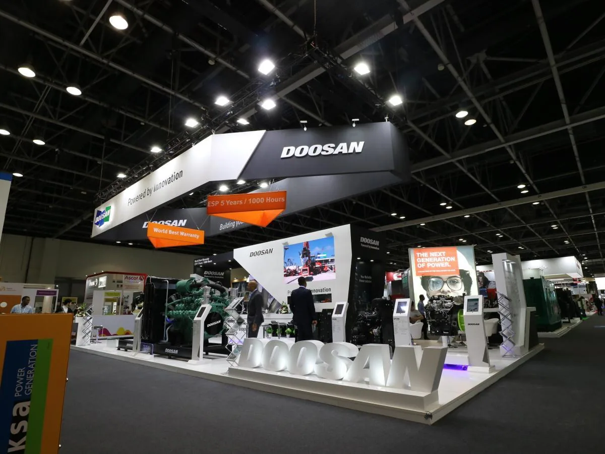 Custom-built DOOSAN exhibition stand with overhead structure and product platforms