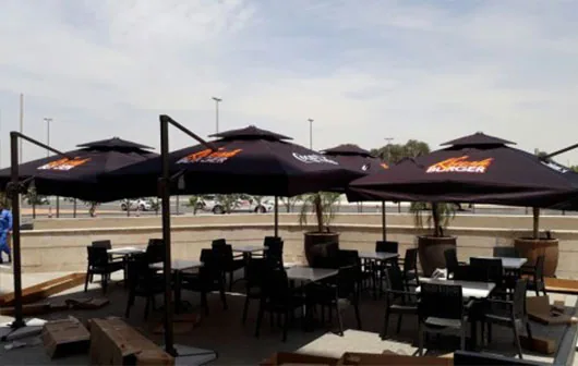 Patio with branded umbrellas and shade