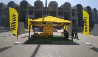 Yellow branded event tent produced for a Nikon activation