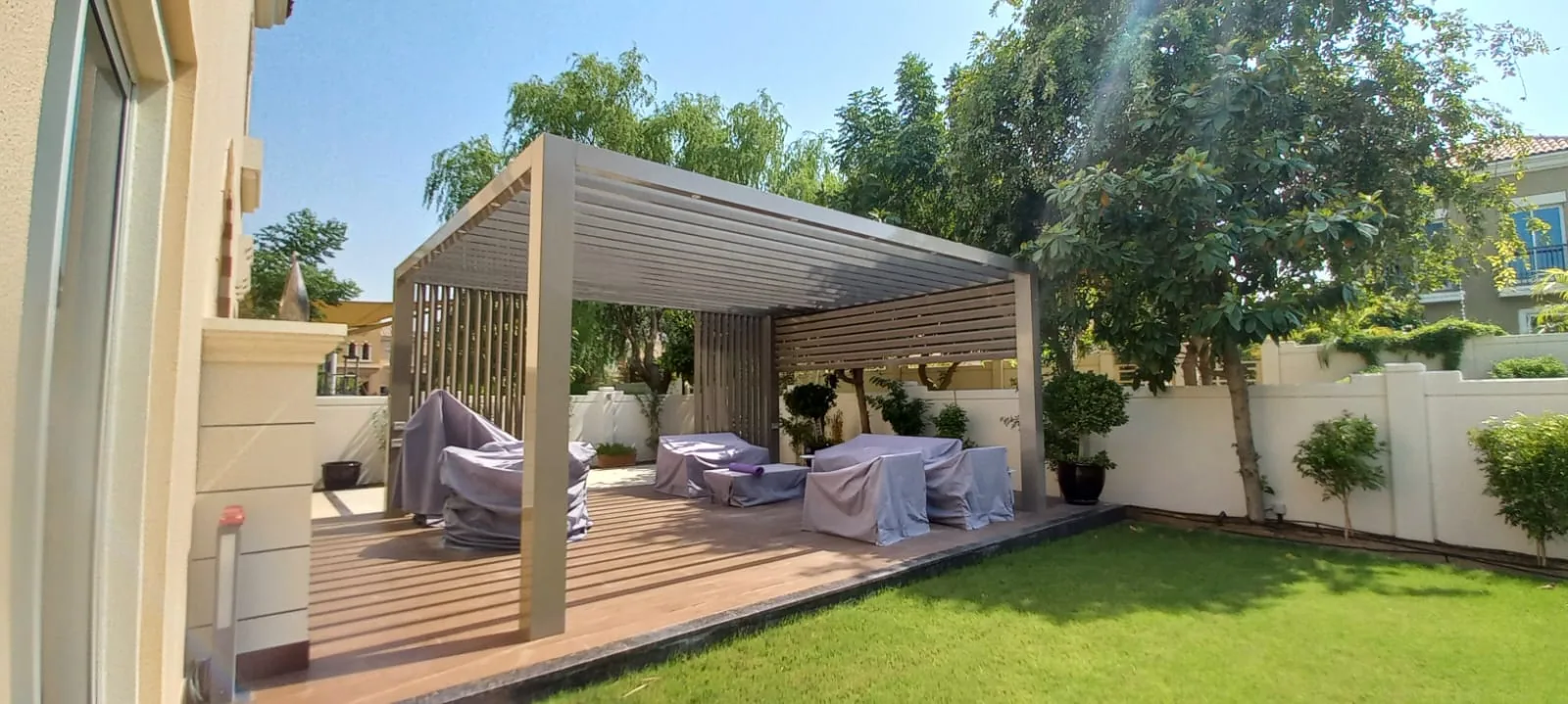 Lush landscaped garden with pergola by Desert Link