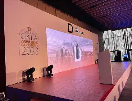 Gala awards ceremony stage set with branded backdrop and lectern