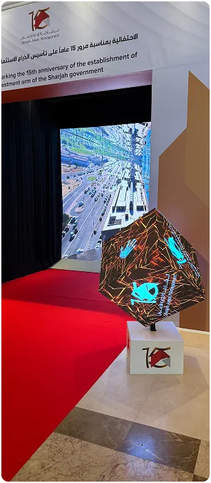 Corporate anniversary installation with sculptural LED cube and red carpet
