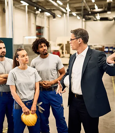 Manager briefing an industrial team on the shop floor