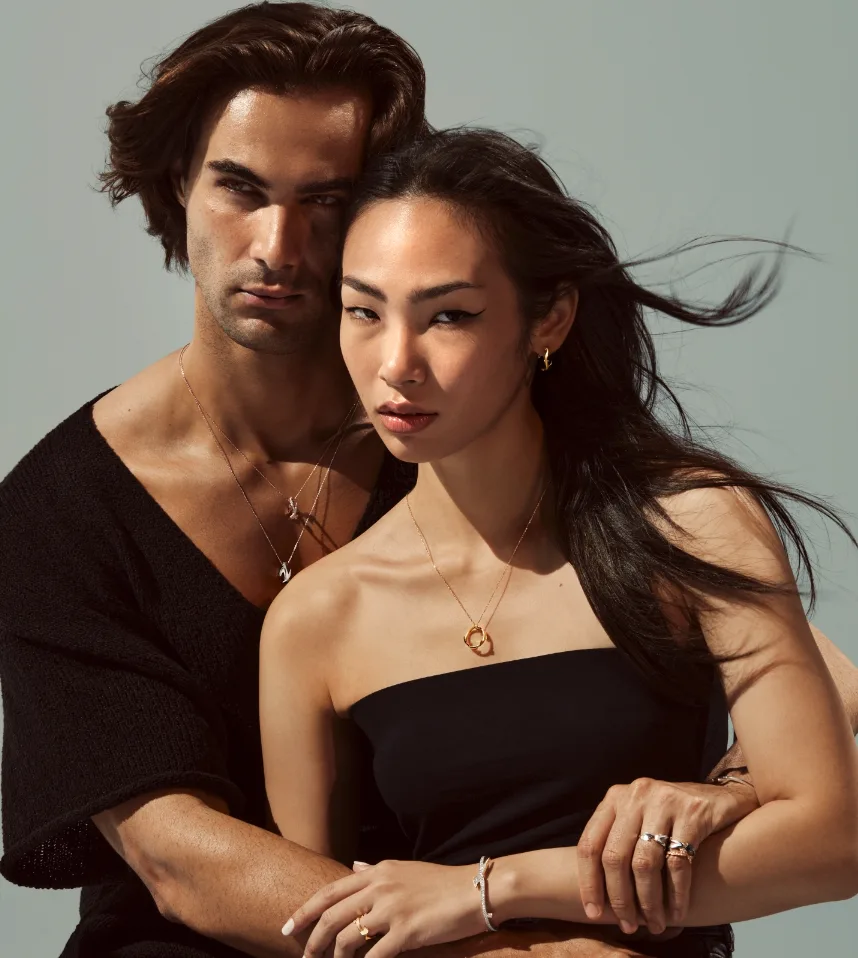 Couple wearing Bil Arabi gold calligraphy necklaces