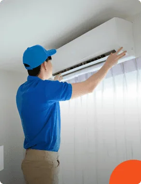 AFTR technician servicing a wall-mounted AC unit
