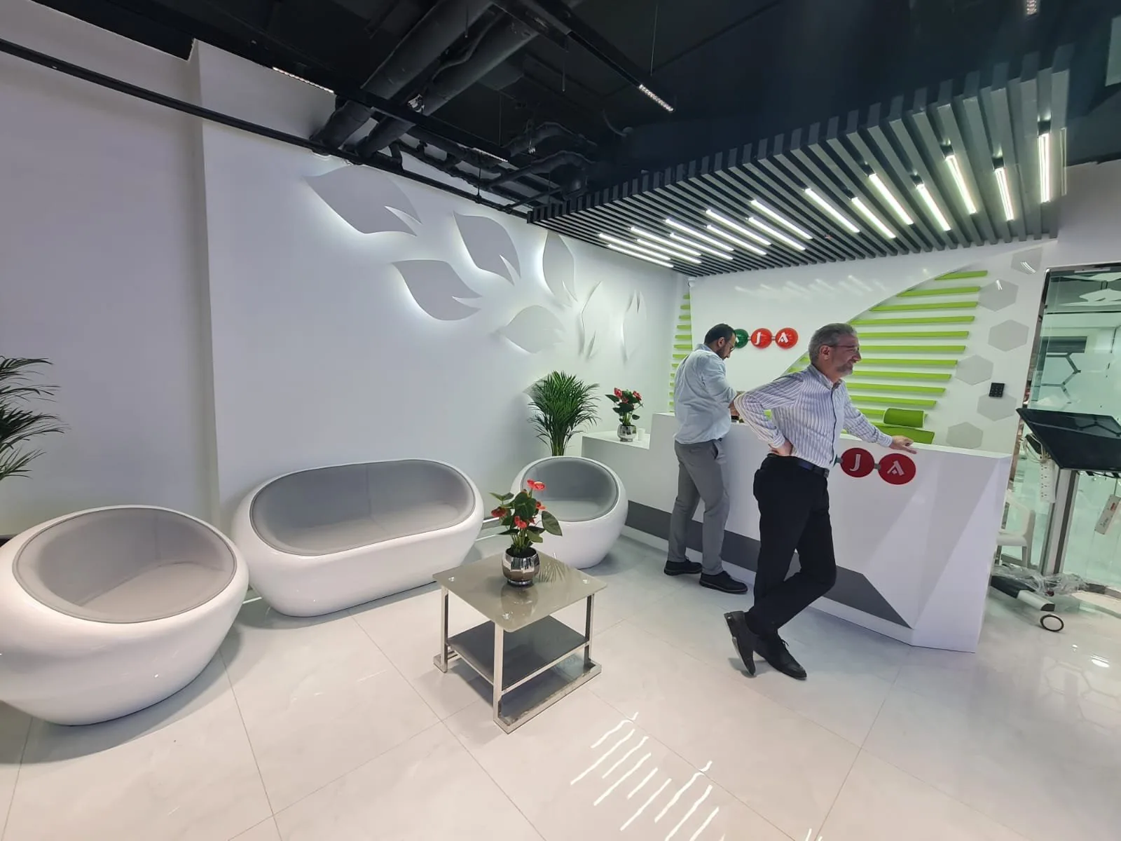 Pharmaceutical office reception lounge with green branding
