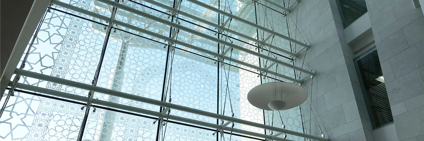 Point-fixed glazed façade with cable-truss support — Al Ahli Bank, Oman