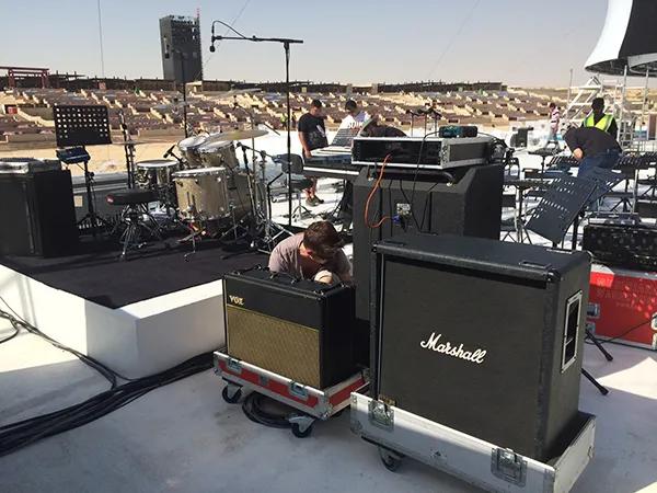 Backline amplifiers and instruments staged for a live event