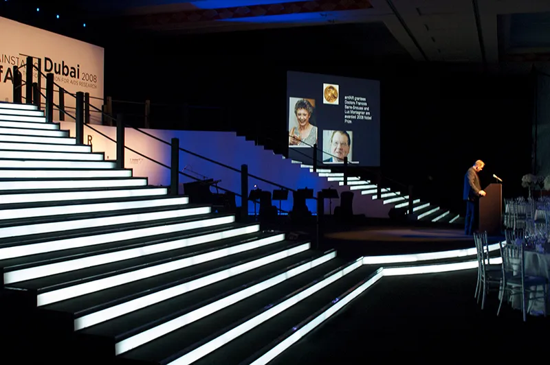 An illuminated stage staircase lit for a gala event in Dubai