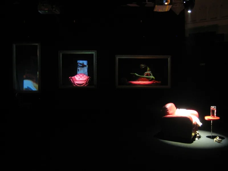Ballroom with a lit dancefloor and stage under blue and pink lighting