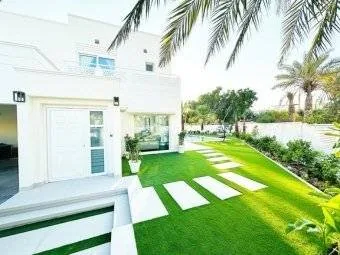 Landscaped Dubai garden with lawn and planting