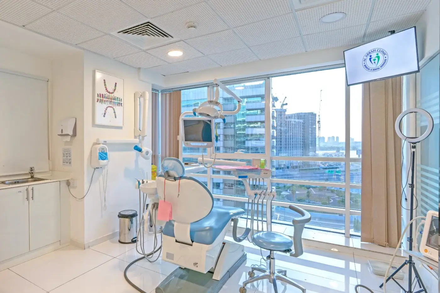 Modern treatment room at Al Abrah Clinic with a Dubai skyline view