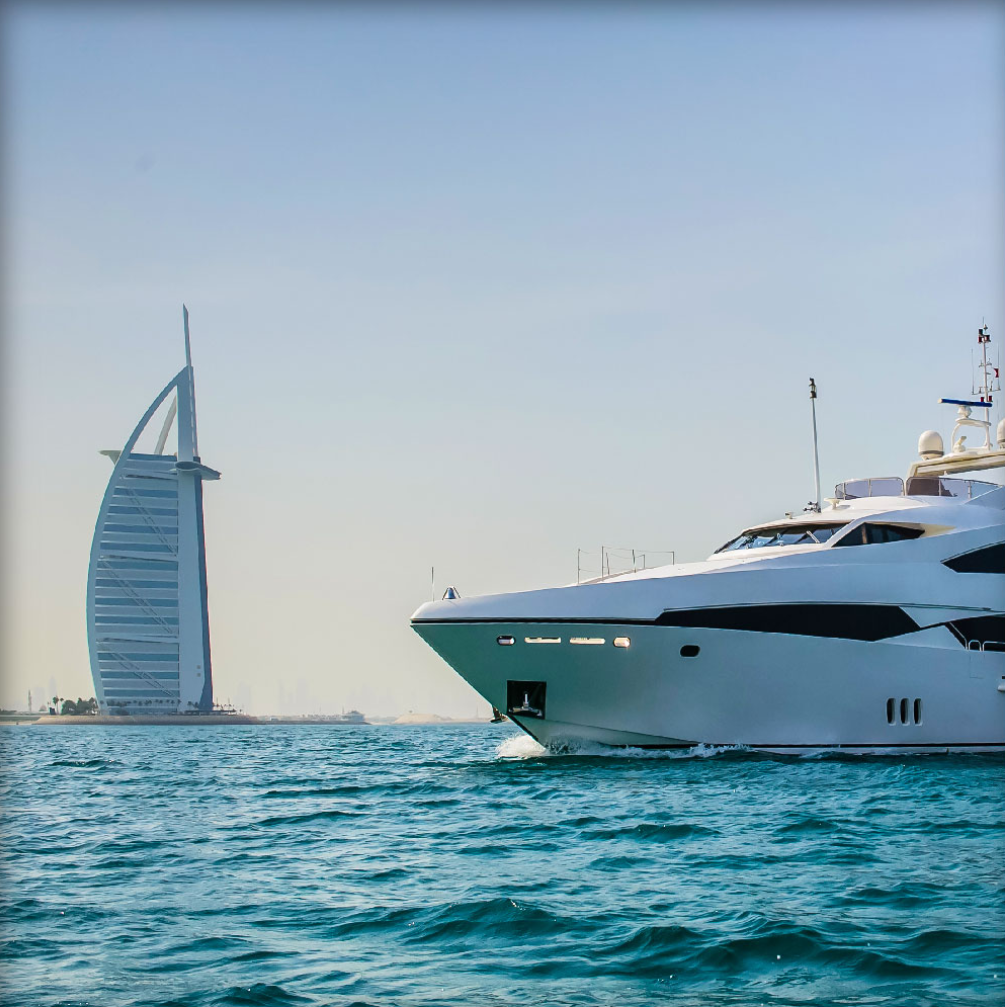 Yacht cruising the Dubai Water Canal at dusk