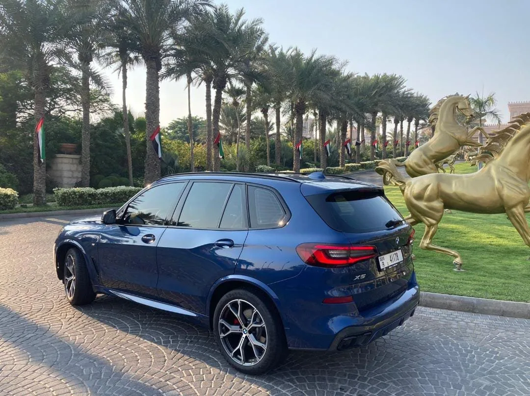 A Rentega fleet vehicle at a Dubai landmark
