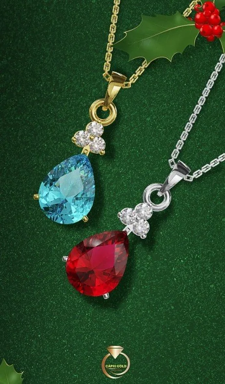 Festive blue topaz and ruby pear pendants